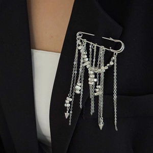 Detail of silver tassel brooch with metal beads on a black suit jacket for parties