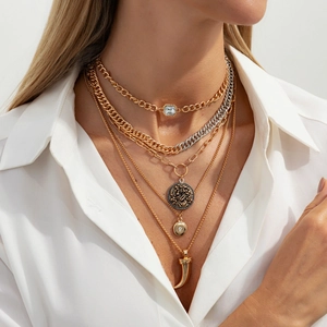 Close-up of layered gold necklaces with star and heart pendants on a female model
