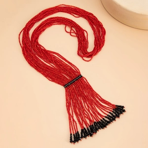 Detail of bohemian red seed bead layered necklace with black bead tassel accents