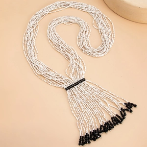 Detail of bohemian multilayered beaded necklace with elegant crystal fringe tassels