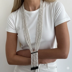 Bohemian multilayer white and black beaded long necklace with tassel fringe on a model