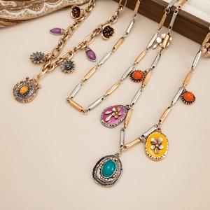 Macro shot of vintage bohemian necklace set with colorful stones and relief pendants