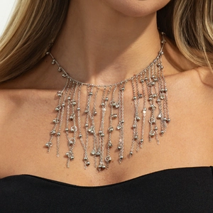 Detail shot of multi-layered silver tassel necklace with tiny metal beads and rhinestones