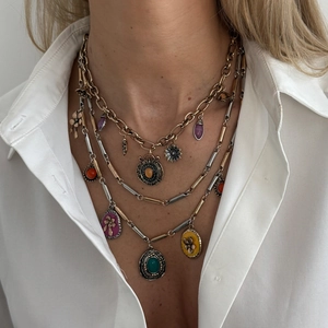 Bohemian multi-layer necklace with heart pendant and colorful enamel charms on model