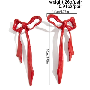 Detail view of red ribbon bow earrings with size 10cm x 4.5cm and weight specifications