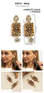 Detailed view of vintage gold alloy earrings with amber resin and rhinestones, 6.5cm length