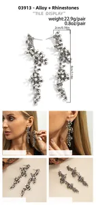 Detail view of vintage coral-style earrings with white rhinestones and dimensions