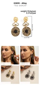 Macro detail of retro crown earrings featuring black resin stones in gold and silver finish