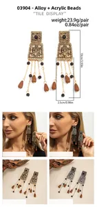 Detail of vintage bohemian tassel earrings with gold-silver plating and acrylic beads