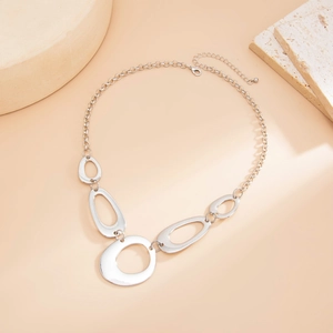 Macro shot of silver geometric ring links and lobster clasp on a modern Y-shaped necklace