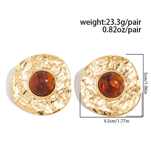 Detail view showing amber resin center and hammered gold texture on retro round earrings