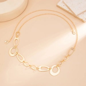 Detailed view of polished golden irregular O-ring geometric metal waist chain link