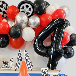 Racing birthday party kit with number 4 balloon checkered flags and tire decorations