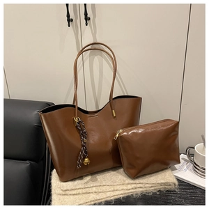 Retro brown waxed leather tote bag set with matching pouch and tassel charm for commuting