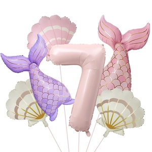 Detail of mermaid party balloon set including matte pink number seven and shell foil designs