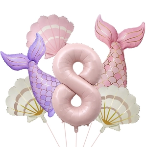 Detail view of pink number 8 mermaid foil balloons set with shells and fish tails