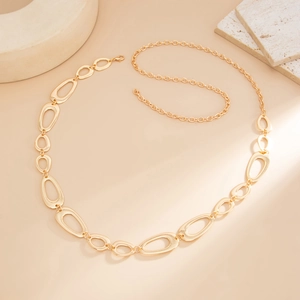 Detail of gold layered waist chain featuring hollow oval links and lobster clasp