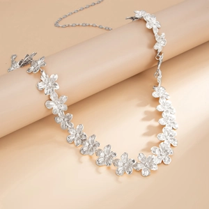Detailed view of silver floral metal waist chain with lobster clasp and extension links