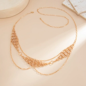 Close-up of golden multi-layer waist chain featuring intricate woven metal diamond textures