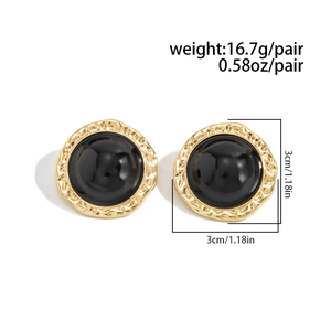 Detailed view of large hammered gold earrings with black dome inlay and size dimensions