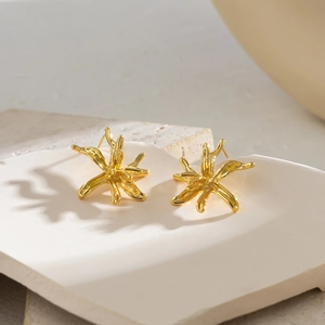Minimalist 18K gold plated irregular floral earrings on white ceramic textured plate