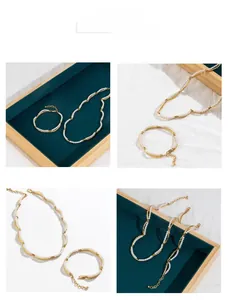 Detail of 18K gold plated bamboo pearl necklace set on vintage velvet tray display