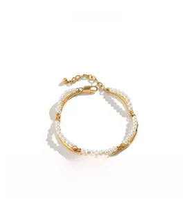 Detail of 18K gold-plated bamboo link bracelet with pearls and lobster clasp closure