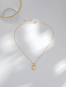 Close-up of gold S925 silver necklace with interlocking geometric rectangular pendants