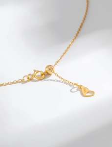 Macro detail of S925 sterling silver lobster clasp with adjustable slider and heart pendant