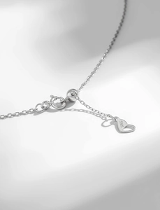 Detail of 925 sterling silver chain with S925 engraved heart tag and spring clasp