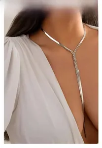 Detail of silver snake bone chain featuring a decorative knot and elegant draped design