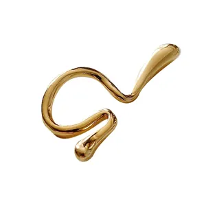 Minimalist gold twisted ear cuff with polished finish and flowing wave design