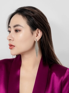 Silver rhombic mesh earrings with sparkling fringe shown on a female model
