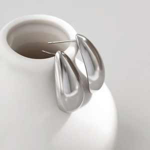 Sleek silver teardrop earrings with a polished mirror finish in a minimalist design