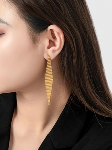 Detail of 18K gold plated brass fringe earrings with woven mesh diamond shape design