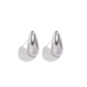 Macro shot of silver teardrop earrings with high-polish mirror finish and smooth texture