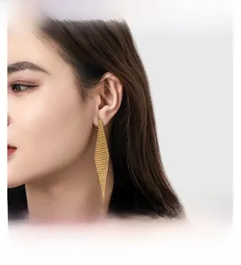 Detail of 18K gold-plated rhombus mesh drop earrings featuring woven hollow metal texture