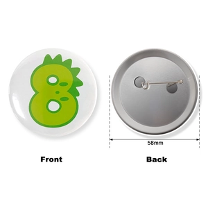 Green cartoon number 8 dinosaur tinplate badge 58mm with front and back pin view