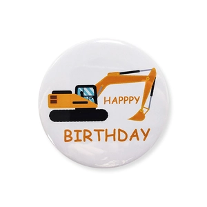 Detailed view of a yellow excavator cartoon badge with Happy Birthday greeting text