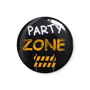 Macro view of the shiny tinplate badge featuring a yellow Party Zone construction design