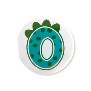 Detailed close-up of a round tinplate badge featuring a cute blue dinosaur number design