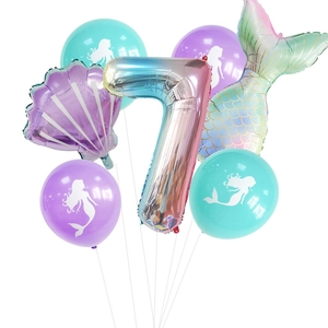 Detail view of mermaid theme party balloons featuring a gradient number 7 and shell foil balloons
