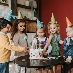 Mermaid party badges and colorful polka dot hats for kids birthday celebrations