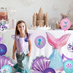 Detail of mermaid birthday party decoration set with balloons and colorful kids dress