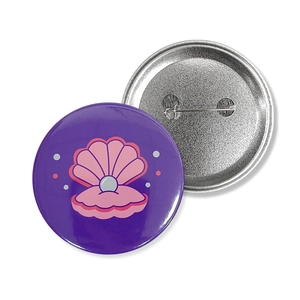Round mermaid theme pin badge with pink shell illustration and metal safety pin back