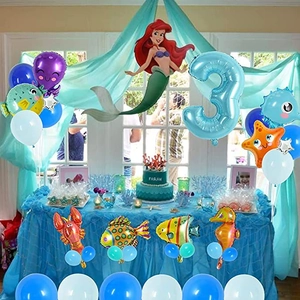 Ocean themed birthday decor with mermaid and sea animal balloons for girl's 3rd party