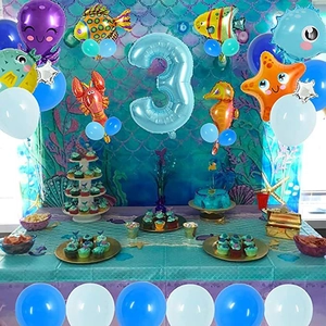 Marine themed 3rd birthday party setup with sea creature balloons and fish scale backdrop