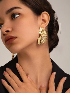 Close-up of elegant 18K gold-plated oversized irregular petal earrings on a model