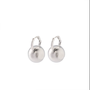 Minimalist matte silver hoop earrings with large brushed metal ball drops in studio light