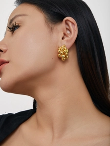 Close-up of elegant 18K gold cluster ball earrings on model showing 3D grape-like structure